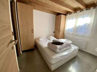 Cozy chalet bedroom with wooden accents and built-in wardrobes.