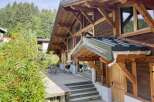 This stunning chalet boasts a spacious deck perfect for outdoor entertaining, complete with a built-in grill.