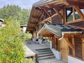 This stunning chalet boasts a spacious deck perfect for outdoor entertaining, complete with a built-in grill.