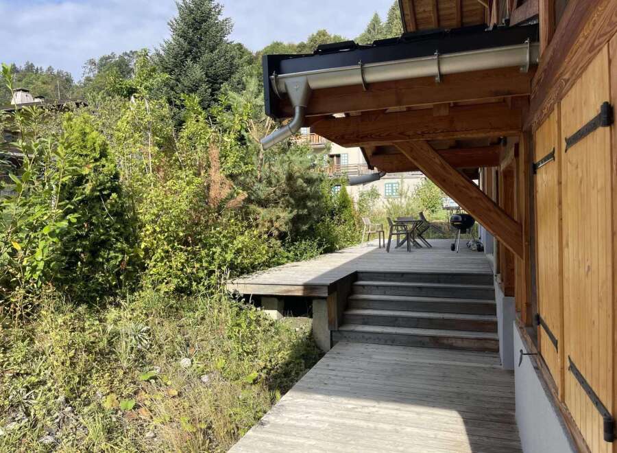 This stunning property boasts a spacious deck perfect for outdoor entertaining, complete with a built-in grill and ample seating.