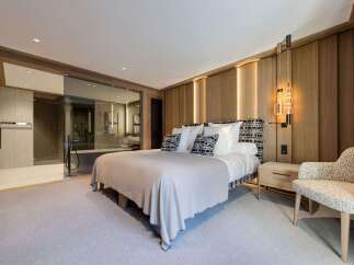 Experience luxury living in this stunning bedroom featuring a modern design and elegant finishes.