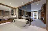 Experience luxury living in this stunning property featuring a spa-like bathroom with a modern soaking tub and elegant fixtures.