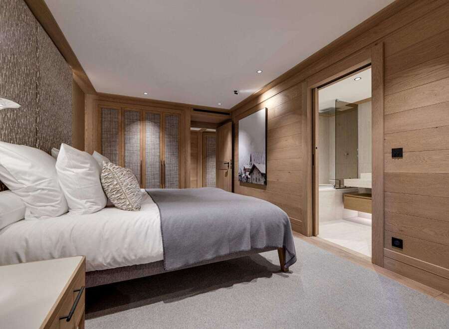Experience luxury in this exquisite bedroom, featuring a cozy bed and a stylish design.