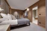 Experience luxury in this exquisite bedroom, featuring a cozy bed and a stylish design.