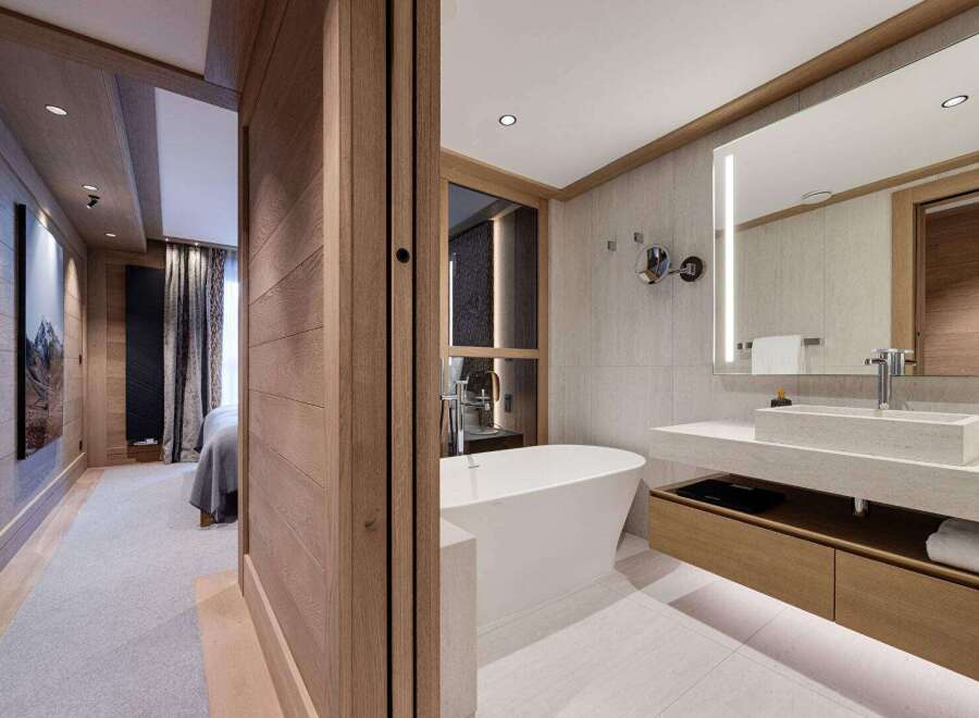 Experience luxury living in this stunning property featuring a modern bathroom with a sleek bathtub and a spacious vanity.