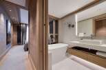 Experience luxury living in this stunning property featuring a modern bathroom with a sleek bathtub and a spacious vanity.