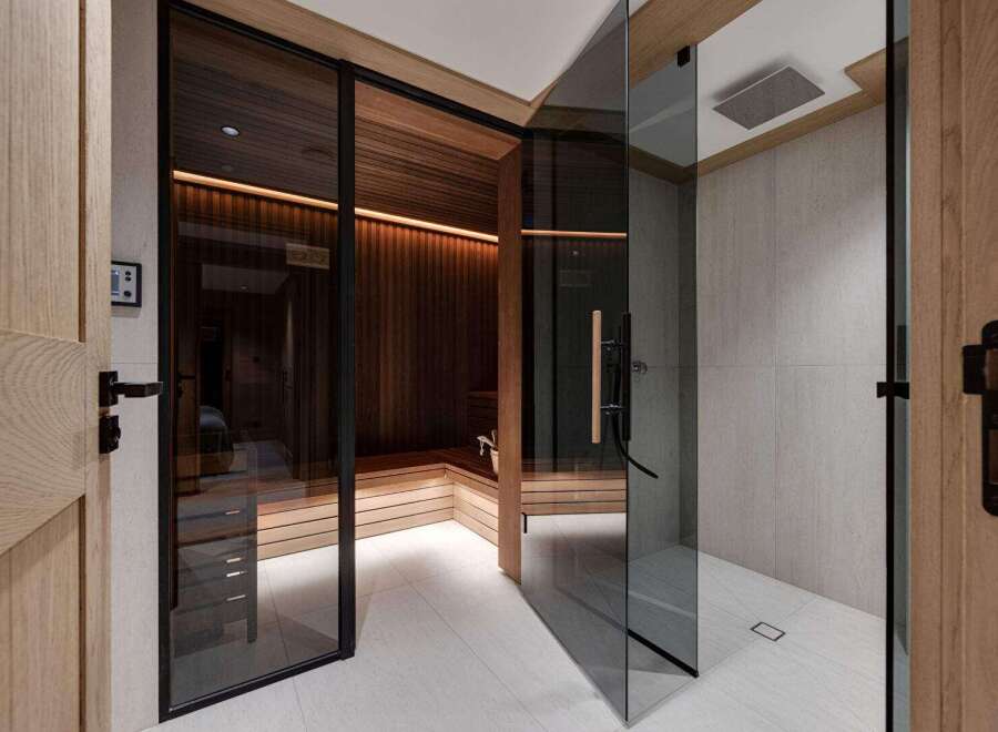Step into luxury with this stunning property featuring a private sauna and a sleek, modern shower.