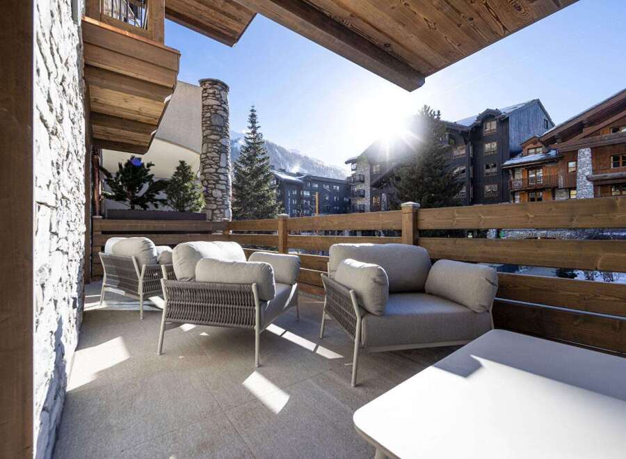Enjoy breathtaking mountain views from this luxurious outdoor seating area.