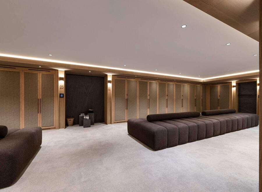 Step into luxury with this spa-like retreat, featuring a serene lounge area perfect for relaxation.