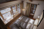 Cozy mountain cabin bedroom with stunning snowy views.