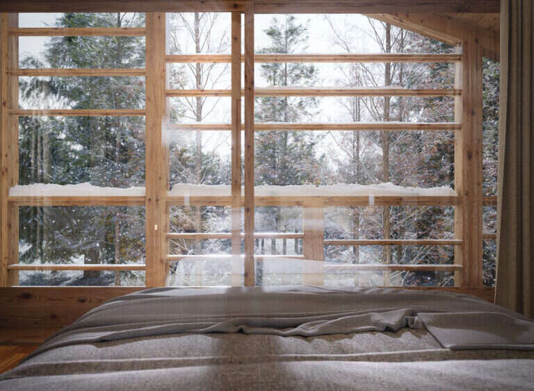 Wake up to breathtaking views of a snow-covered forest from this cozy bedroom.