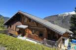Nestled in a picturesque mountain setting, this charming wooden chalet offers a tranquil retreat.