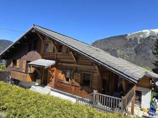 Nestled in a picturesque mountain setting, this charming wooden chalet offers a tranquil retreat.