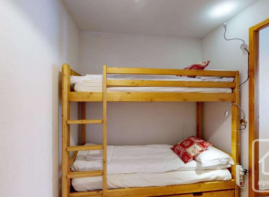 Cozy bunk beds in a charming room, perfect for a family getaway.