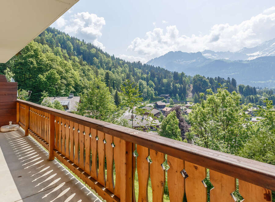 Enjoy breathtaking mountain views from this charming balcony.
