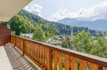 Enjoy breathtaking mountain views from this charming balcony.