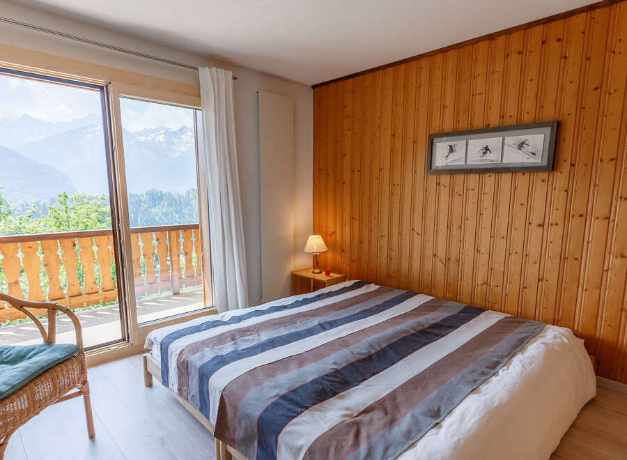 Enjoy breathtaking mountain views from this cozy bedroom.