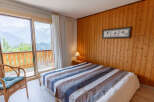 Enjoy breathtaking mountain views from this cozy bedroom.