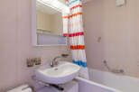 This charming bathroom features a classic design with tiled walls and a functional layout.