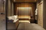 Luxurious spa-like bathroom with a sauna and a modern shower.