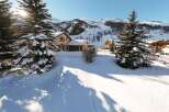 This stunning chalet boasts a picturesque winter setting, nestled amidst snow-covered fir trees and breathtaking mountain views.