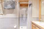 This charming bathroom features a cozy shower area with a stylish curtain.
