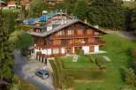 Discover a stunning chalet nestled in a picturesque mountain setting.