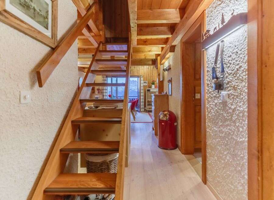 Discover the charm of this cozy property, featuring a beautiful wooden staircase that leads to a bright and airy space.