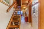 Discover the charm of this cozy property, featuring a beautiful wooden staircase that leads to a bright and airy space.
