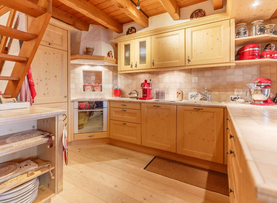 This charming kitchen boasts a warm, inviting atmosphere with its wooden cabinetry and flooring.