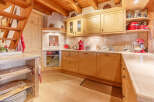 This charming kitchen boasts a warm, inviting atmosphere with its wooden cabinetry and flooring.
