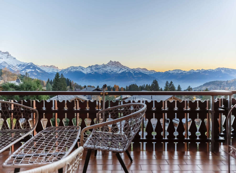 Enjoy breathtaking mountain views from this charming balcony.