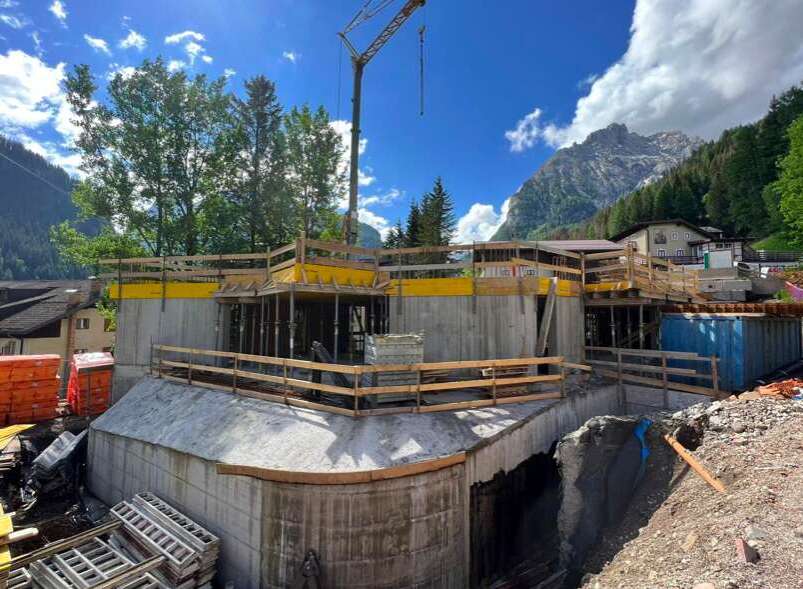 Construction site with a crane in action, showcasing the progress of a new building.