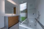 This modern bathroom boasts a sleek design with a combination of wood and concrete elements.