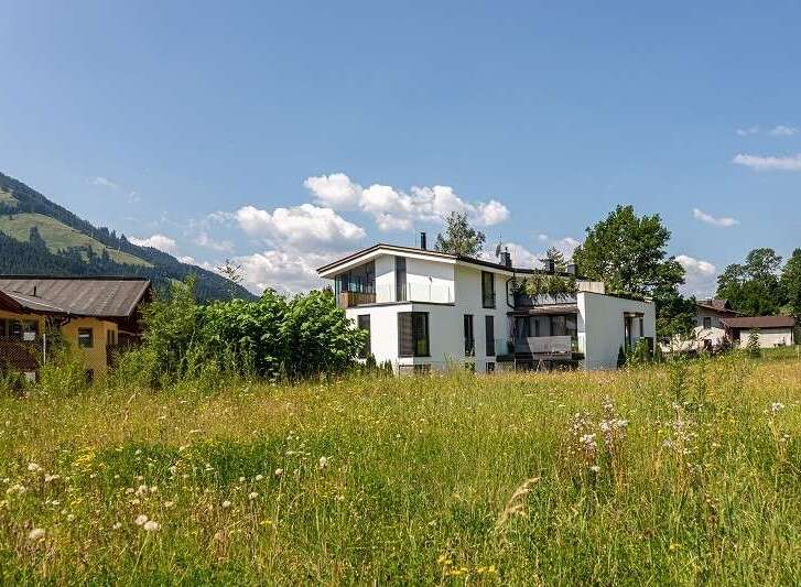Discover a stunning modern home nestled in a picturesque landscape.