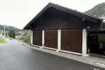 This property features a charming garage with three doors, perfect for storing vehicles or equipment.