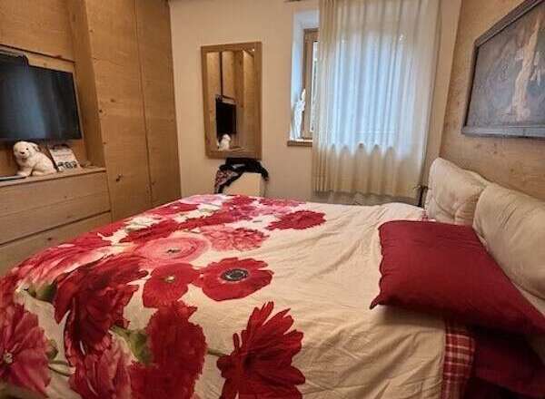 Cozy bedroom with a floral duvet cover and a comfortable bed.
