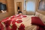 Cozy bedroom with a floral duvet cover and a comfortable bed.