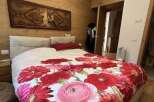 This bedroom features a stunning floral duvet cover that adds a pop of color and personality.