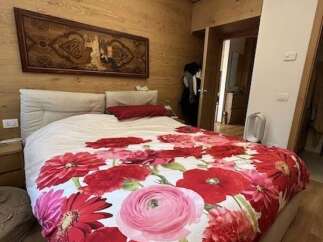 This bedroom features a stunning floral duvet cover that adds a pop of color and personality.