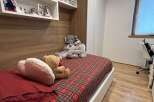 Cozy bedroom with a comfortable bed featuring a vibrant plaid pattern.