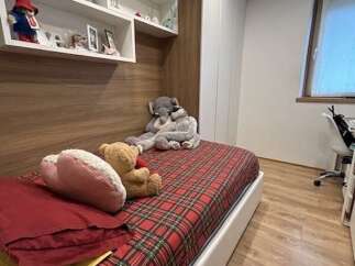Cozy bedroom with a comfortable bed featuring a vibrant plaid pattern.