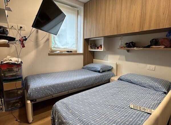 Cozy bedroom featuring two twin beds, perfect for guests or roommates.