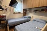 Cozy bedroom featuring two twin beds, perfect for guests or roommates.