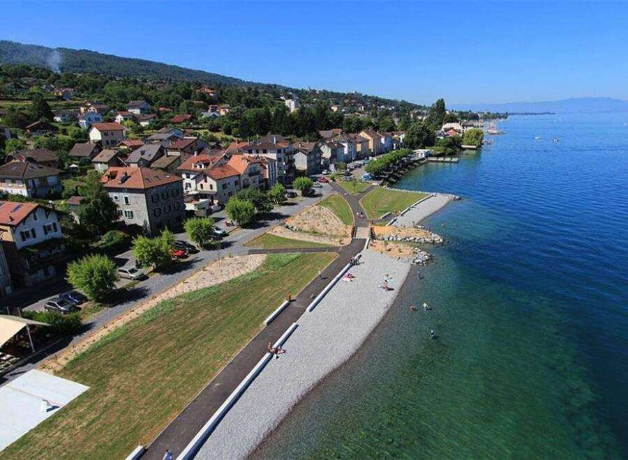 Discover the serene beauty of this lakeside property, featuring a private beach and stunning mountain views.