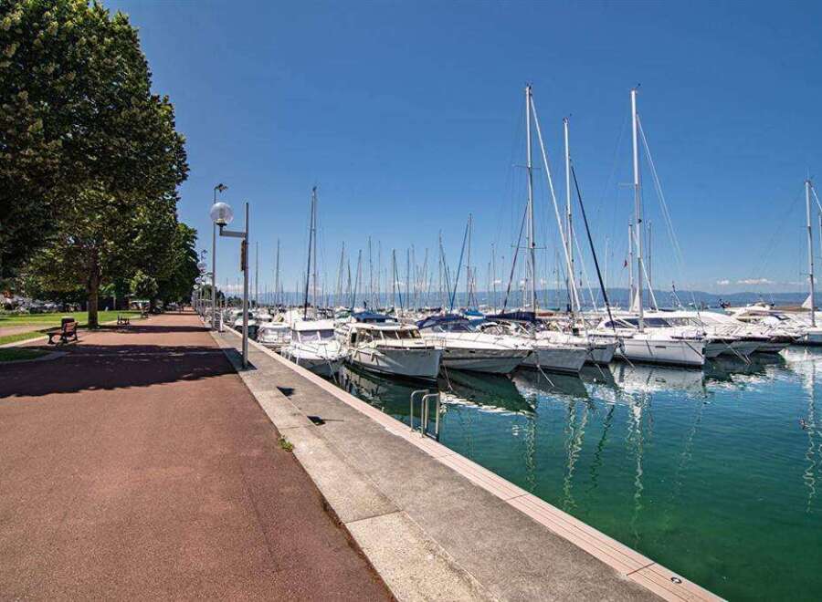 Discover the serene beauty of this waterfront property, boasting stunning views of a marina filled with yachts and sailboats.