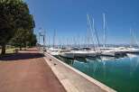 Discover the serene beauty of this waterfront property, boasting stunning views of a marina filled with yachts and sailboats.