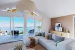 Stunning lake views from this spacious living area, featuring a light and airy design.