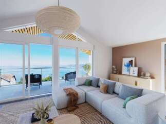 Stunning lake views from this spacious living area, featuring a light and airy design.