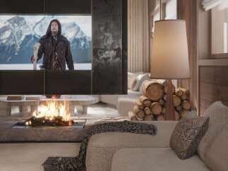 Cozy mountain chalet with a stunning fireplace and large screen TV perfect for movie nights.